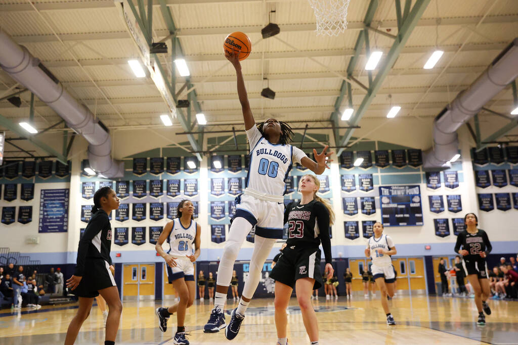 Centennial's Kaniya Boyd (00) shoots the ball as Faith Lutheran's Raina Forgue (23) looks on du ...