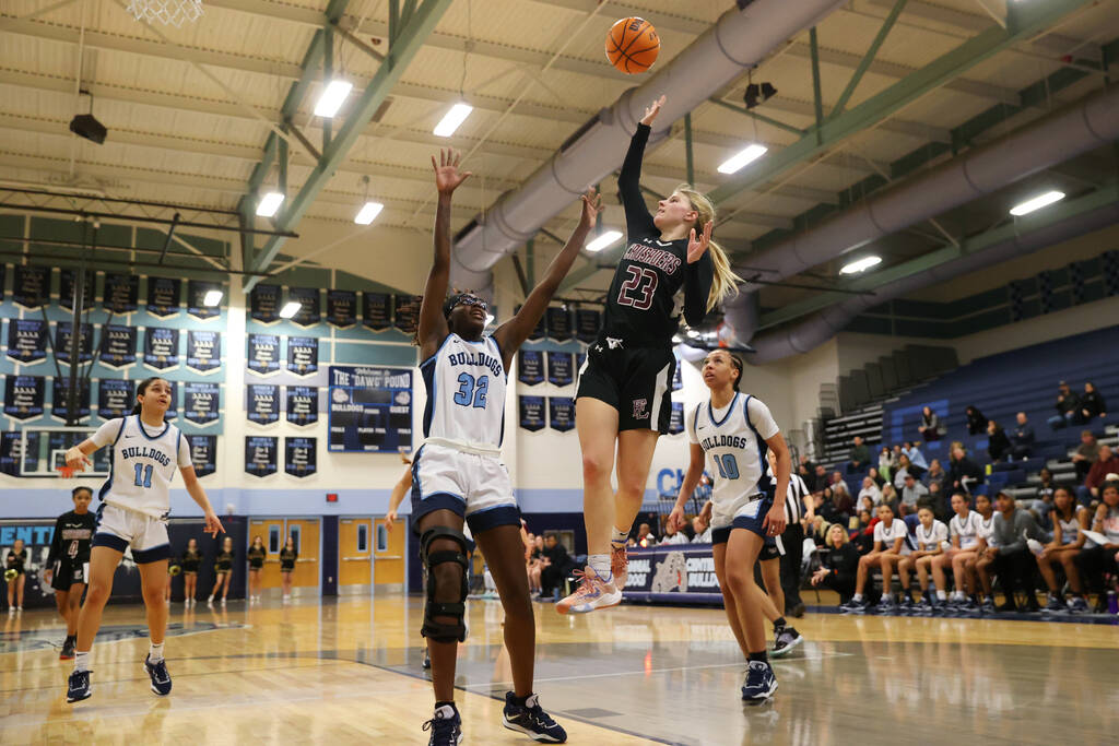 Faith Lutheran's Raina Forgue (23) shoots a basket over Centennial's Asani Ceaser (3) during a ...