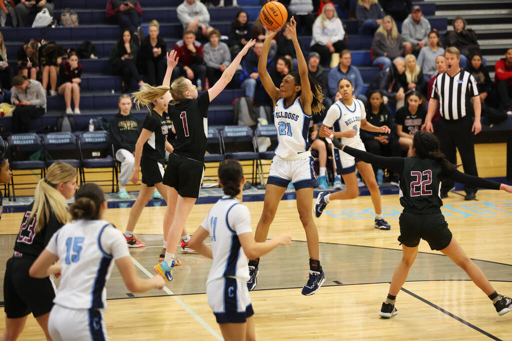 Centennial's Cici Ajomale (21) takes a shot against Faith Lutheran's Sami Monighetti (1) during ...