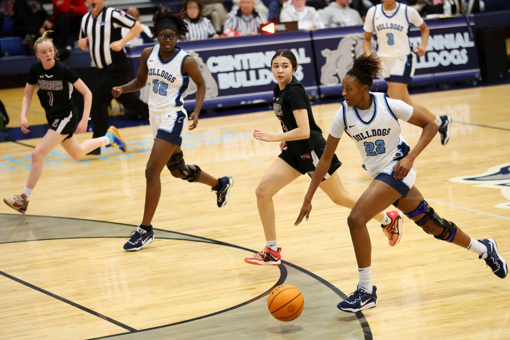 Centennial's Kaliyah Dillard (22) dribbles the ball to the basket as Faith Lutheran's Emma Herp ...