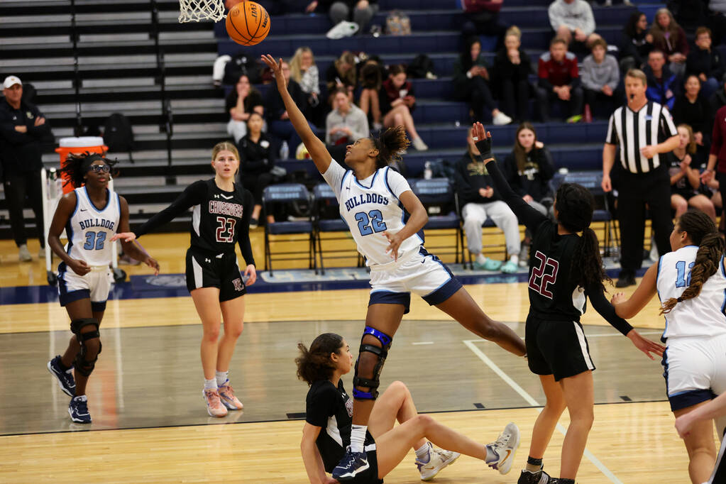 Centennial's Kaliyah Dillard (22) takes a shot against Faith Lutheran during a girls class 5A s ...