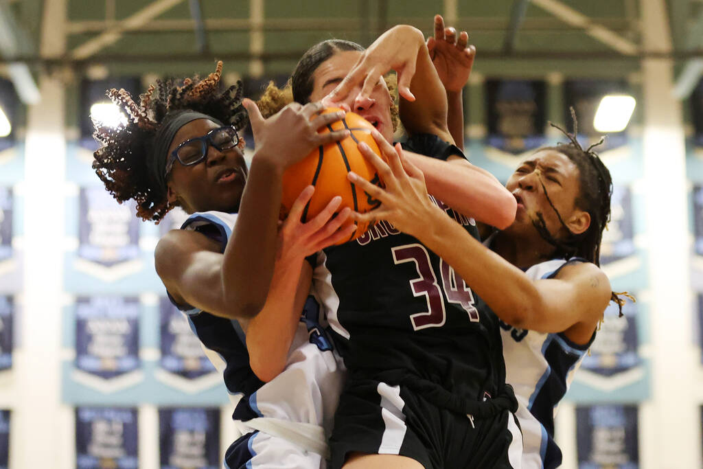 Faith Lutheran's Leah Mitchell (34) is blocked while taking a shot under pressure from Centenni ...