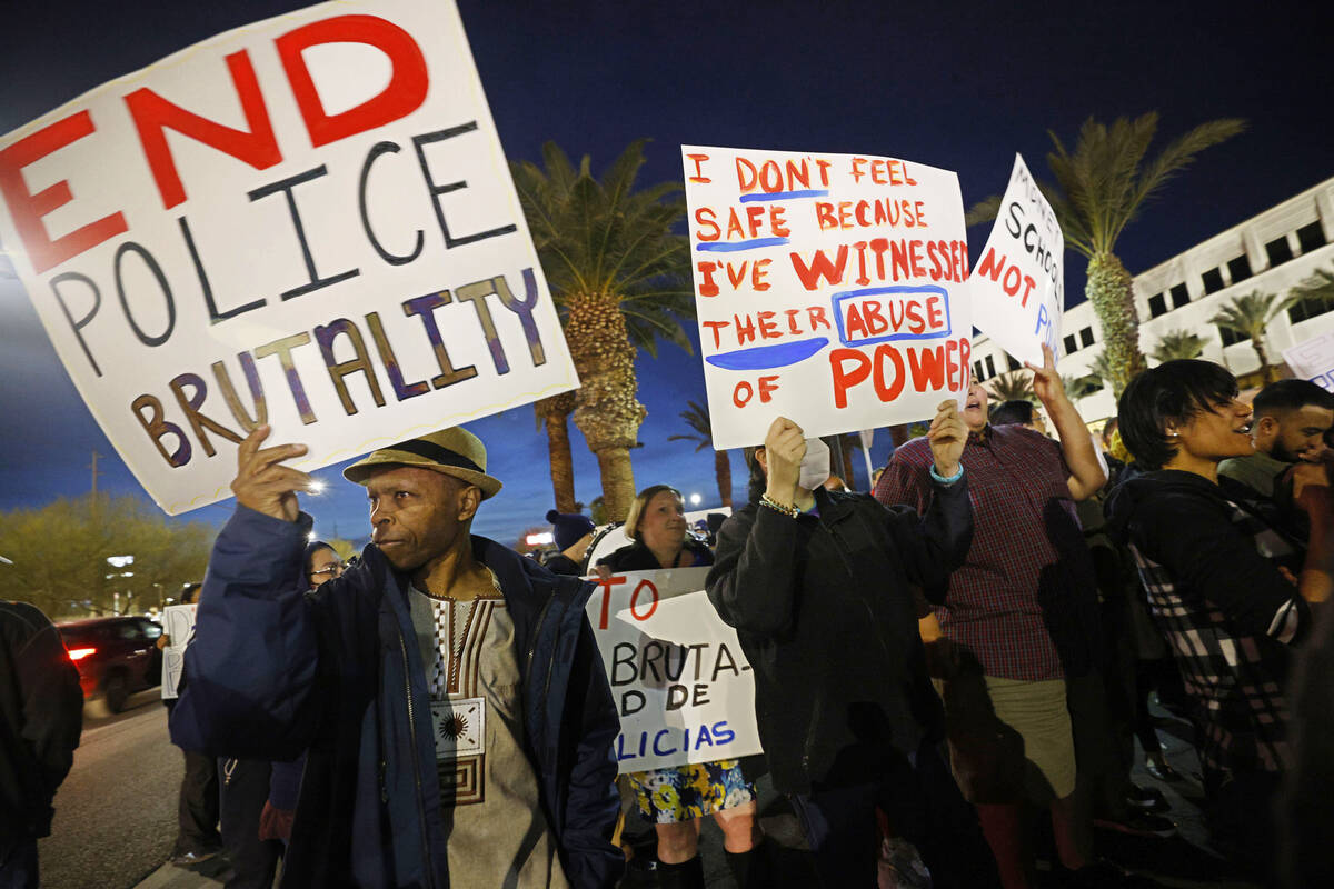 Protesters including Bernard Walker of Las Vegas, left, hold signs outside the Clark County Sch ...