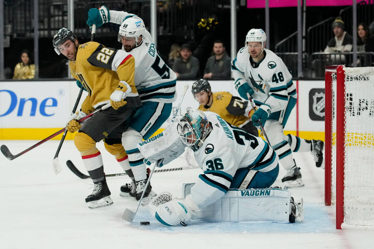 San Jose Sharks goaltender Kaapo Kahkonen (36) covers the puck against the Vegas Golden Knights ...