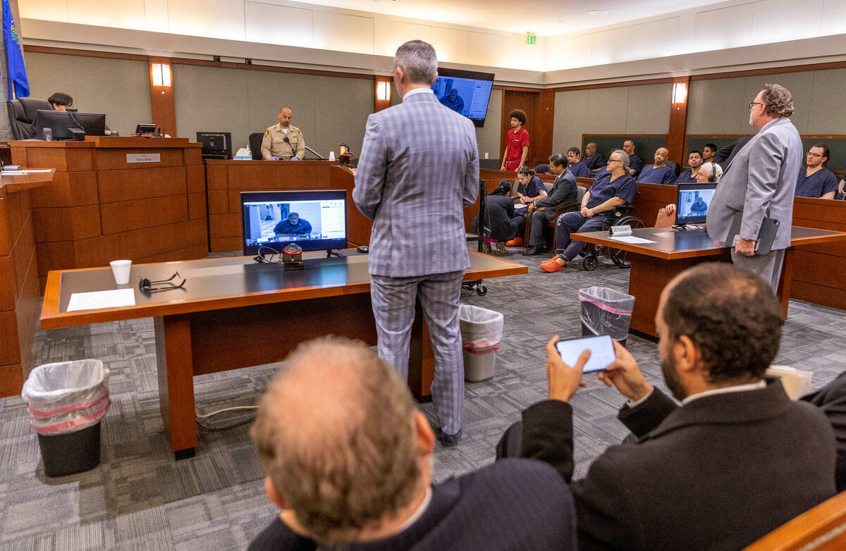 Tyson Hampton, center rear, stands before Judge Tierra Jones to plead "not guilty" to ...