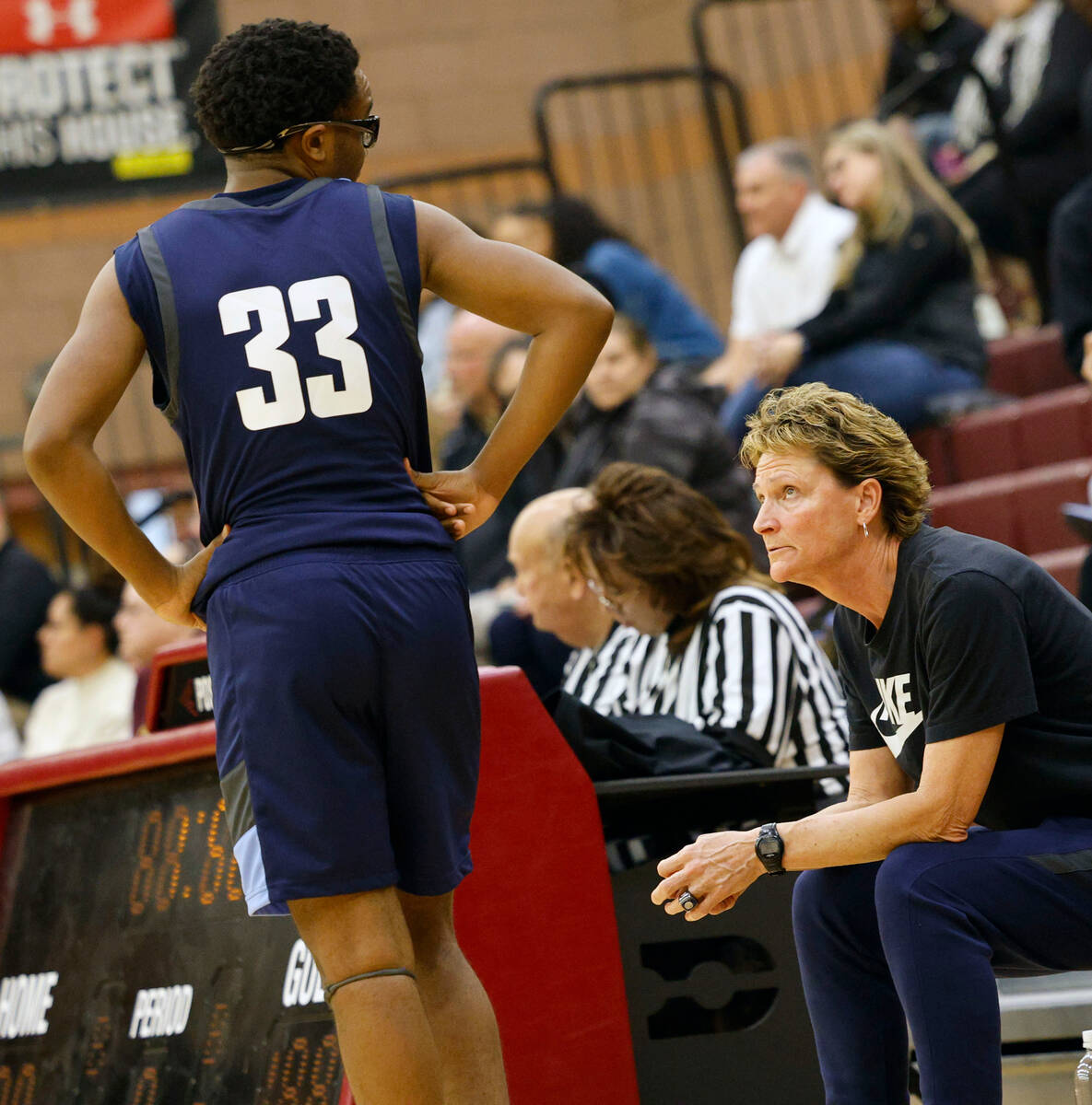 Centennial's head coach Karen Weitz, talks with LaDainian Ivery (33) during the first half of a ...