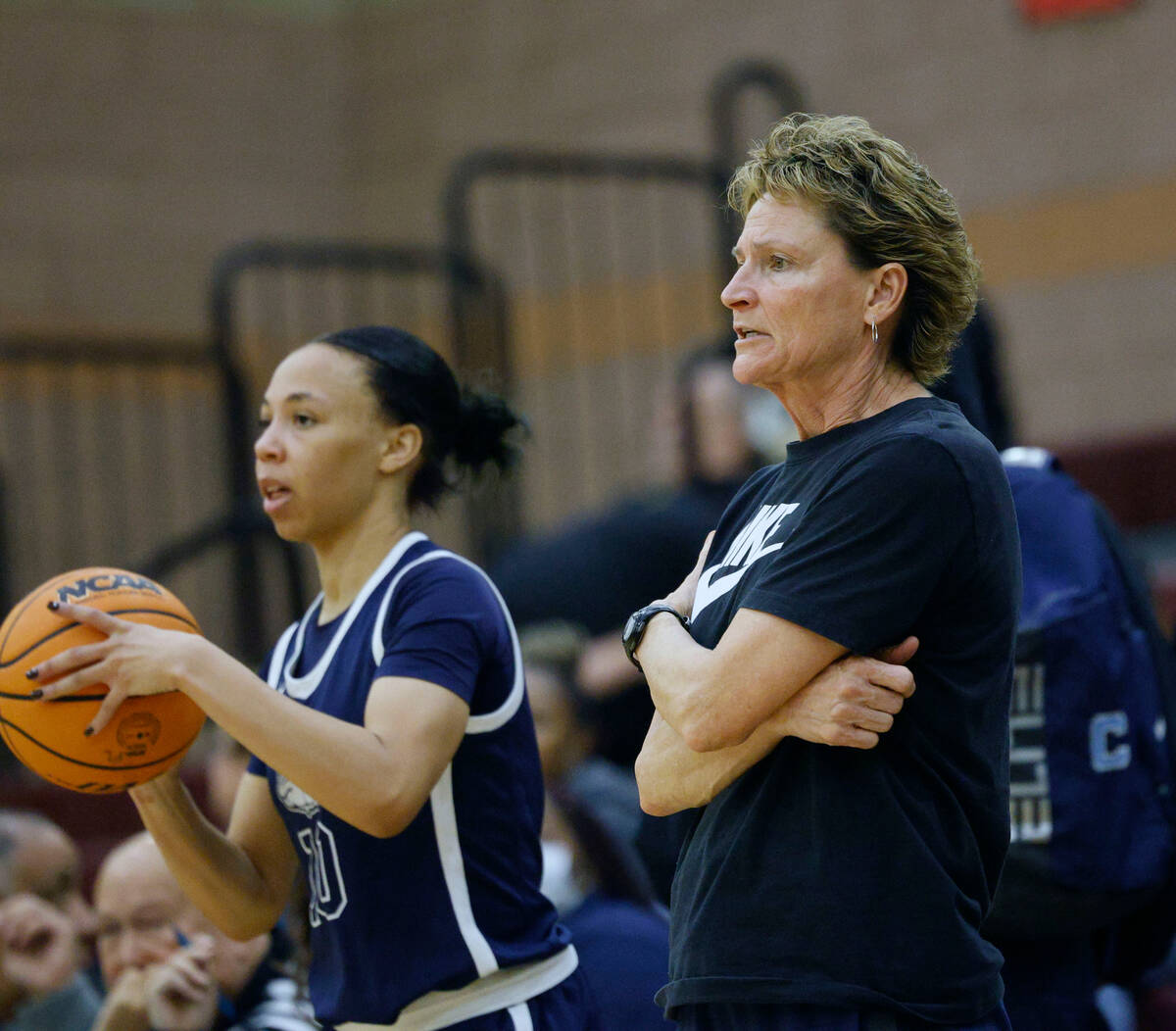 Centennial's coach Karen Weitz, right, watches as Centennial's Tayla Perkins (10) throws a ball ...