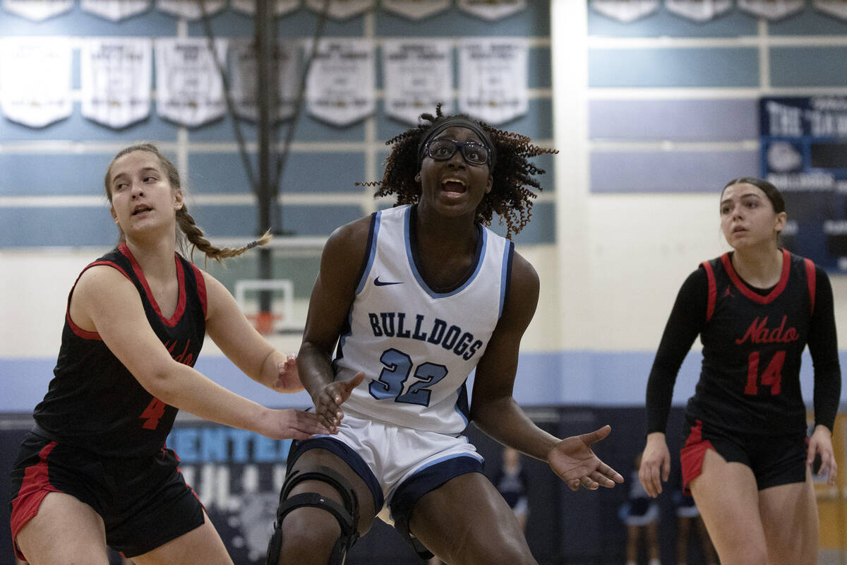 Centennial’s Asani Ceaser (32) reaches after losing control of the ball while Coronado&# ...