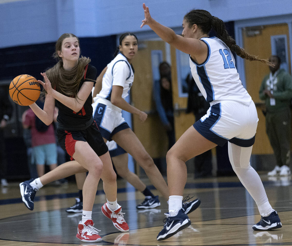 Coronado’s Ella Creer passes while Centennial’s Ayla Wiliiams (12) guards her dur ...