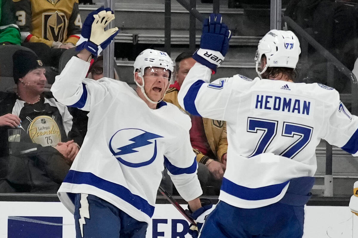 Tampa Bay Lightning right wing Corey Perry, left, celebrates after scoring against the Vegas Go ...