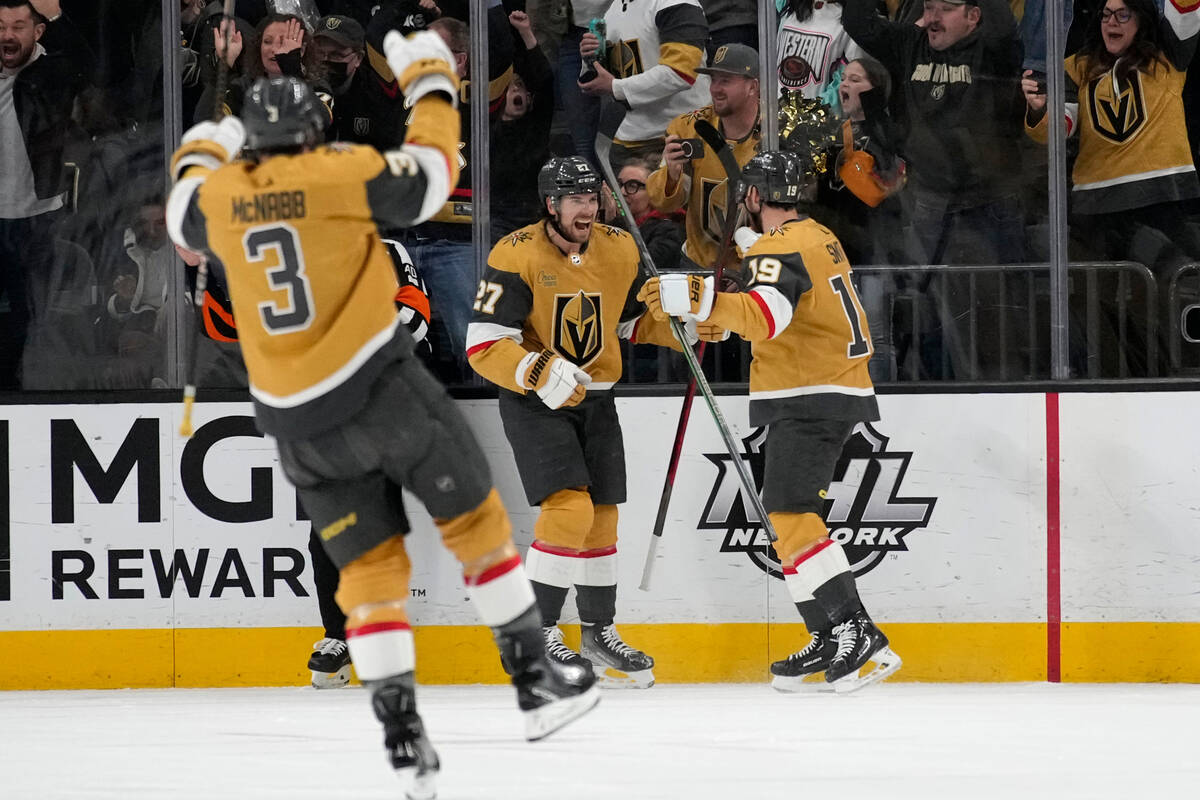 Vegas Golden Knights defenseman Shea Theodore, center, celebrates after scoring against theTamp ...