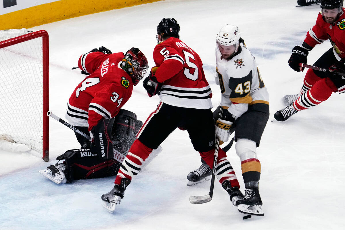 Vegas Golden Knights center Paul Cotter (43) tries to stop the puck against Chicago Blackhawks ...