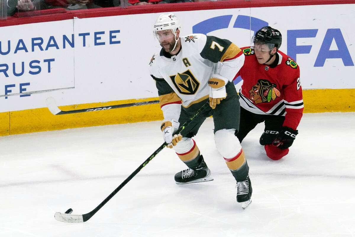 Vegas Golden Knights defenseman Alex Pietrangelo, left, looks to pass past Chicago Blackhawks c ...