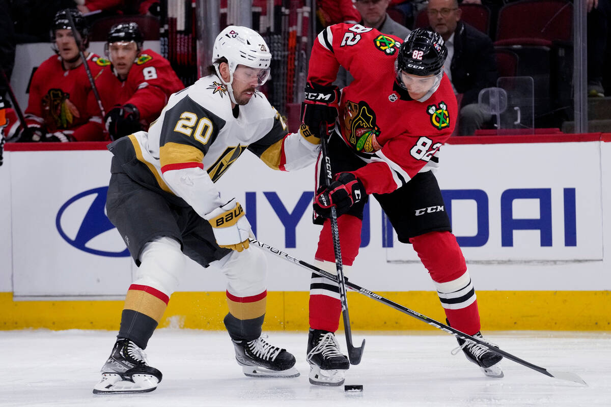 Vegas Golden Knights center Chandler Stephenson, left, and Chicago Blackhawks defenseman Caleb ...