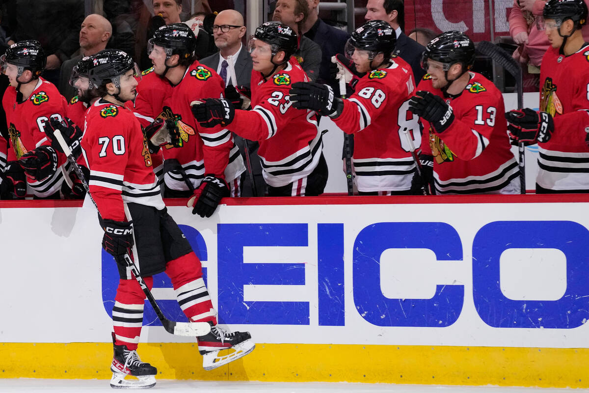 Chicago Blackhawks center Cole Guttman (70) celebrates with teammates after scoring a goal agai ...