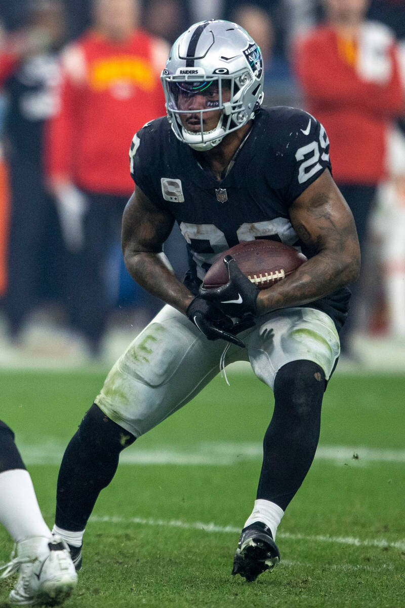 Raiders running back Josh Jacobs (28) looks for room to run against the Kansas City Chiefs duri ...