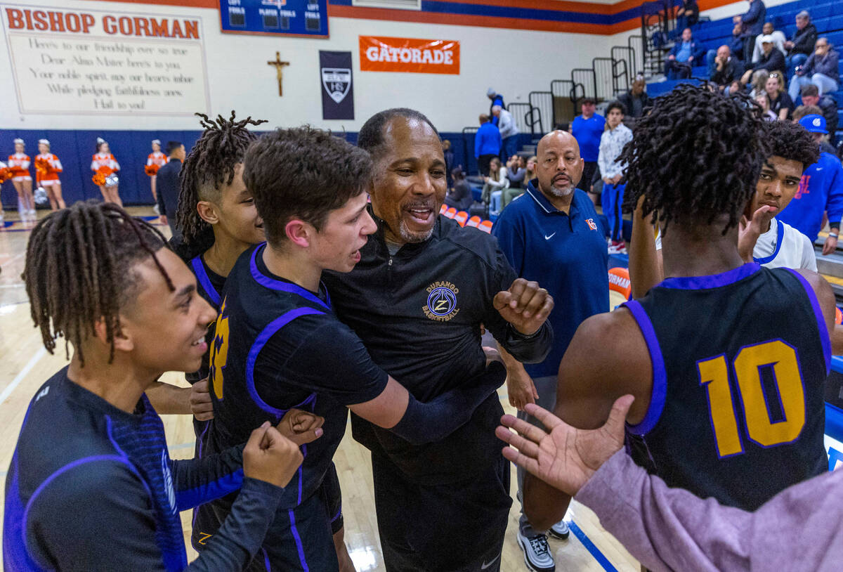 Durango Interim Head Coach Michael Lee is celebrated with his players after defeating Bishop Go ...