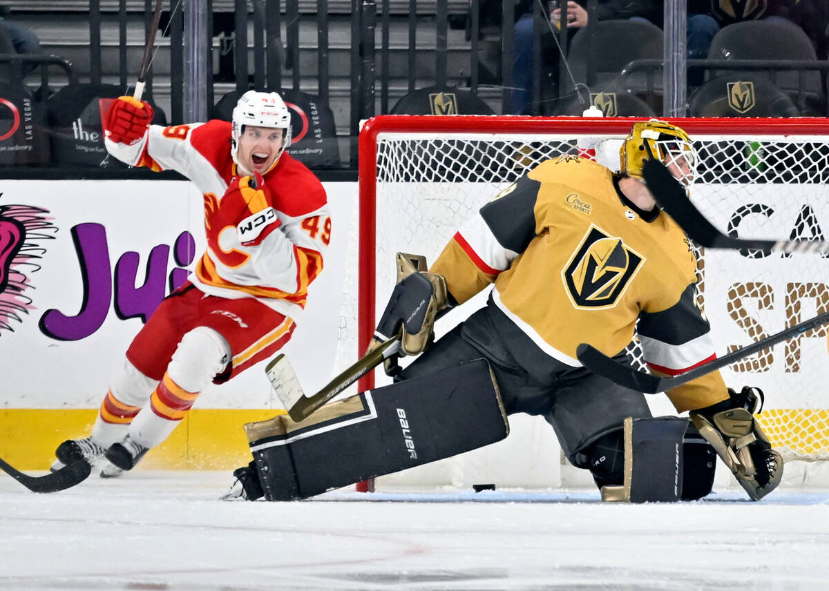 Calgary Flames left wing Jakob Pelletier (49) reacts after a goal against Vegas Golden Knights ...