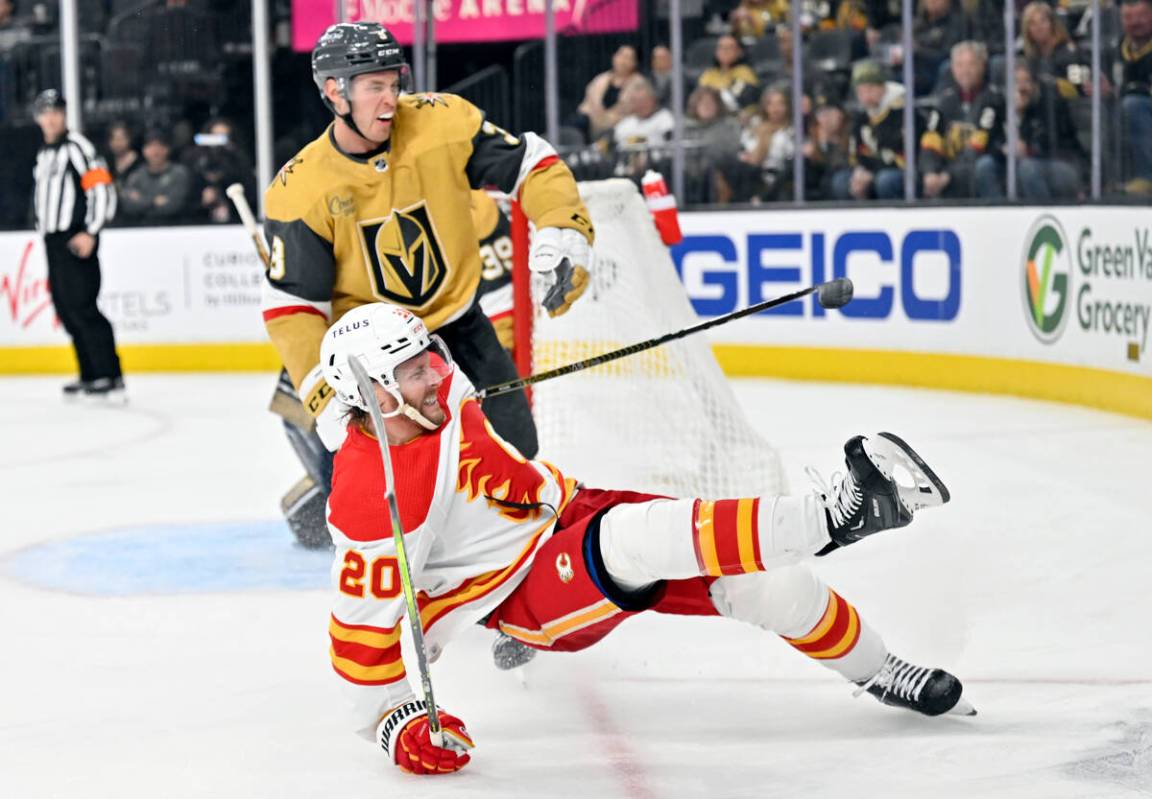 Calgary Flames center Blake Coleman (20) falls to the ice near Vegas Golden Knights defenseman ...