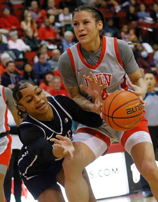 Utah State Aggies guard Isabella Tanedo (2), left, and UNLV Lady Rebels guard Essence Booker (2 ...