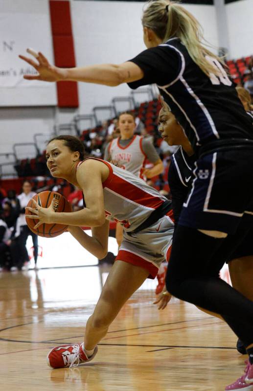 UNLV Lady Rebels guard Kiara Jackson (3), right, looks to pass against Utah State Aggies guard ...