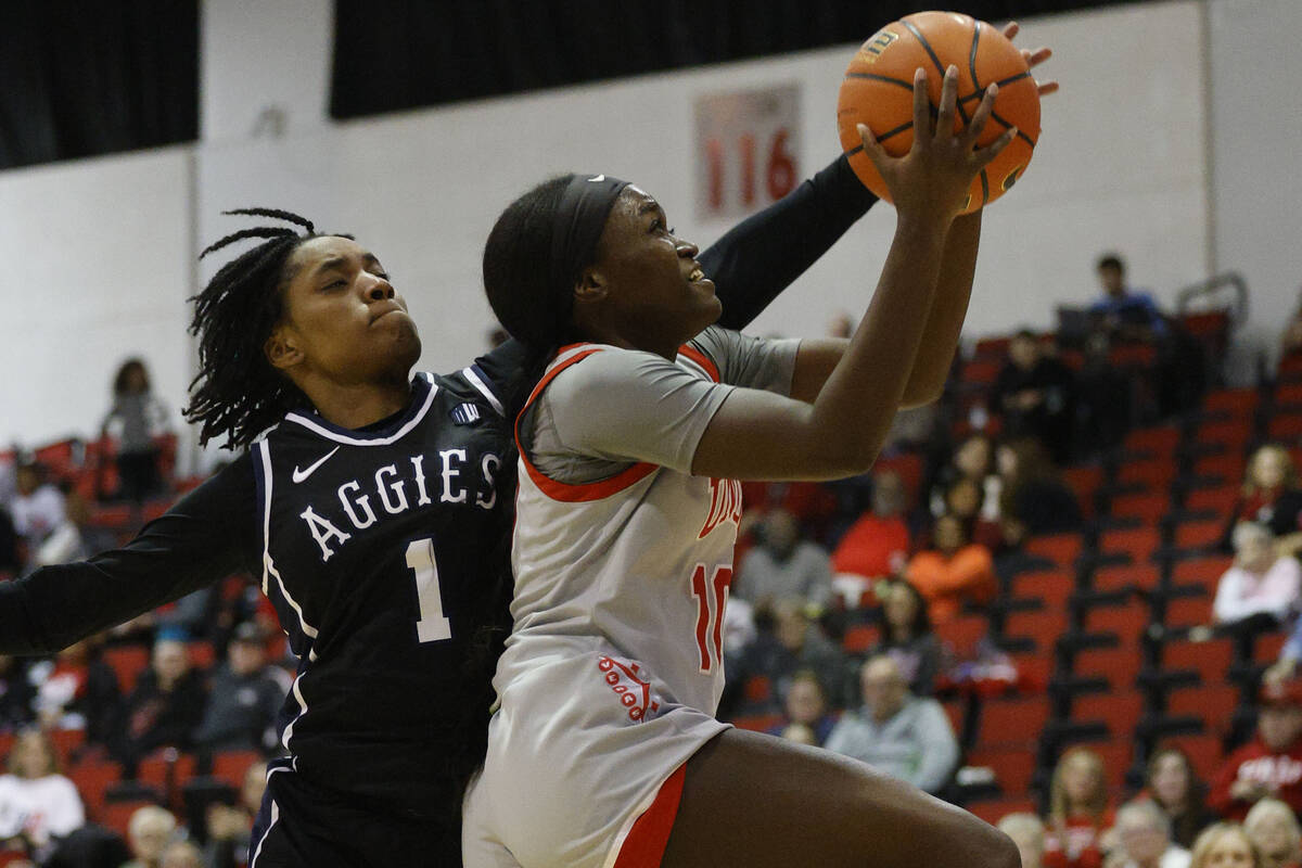 UNLV Lady Rebels guard Jasmyn Lott (10) attempts a jump shot as Utah State Aggies guard Tamiah ...