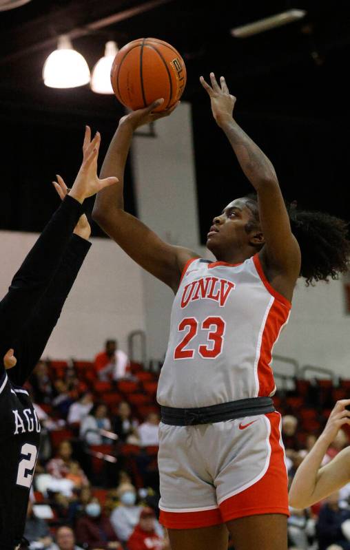 UNLV Lady Rebels center Desi-Rae Young (23) attempts a jump shot against Utah State Aggies guar ...