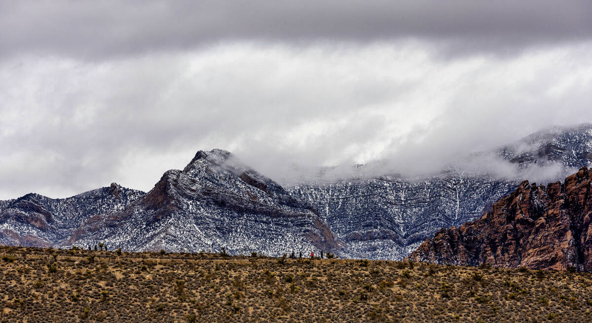 Visitors hike about the Red Rock Canyon National Conservation Area where scenic loop is tempora ...