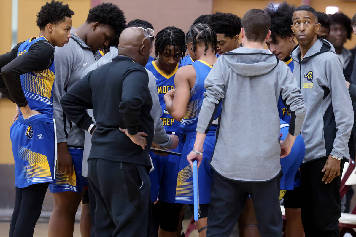 Democracy Prep assistant coach Mark Coleman checks the clock during a time out in a game agains ...