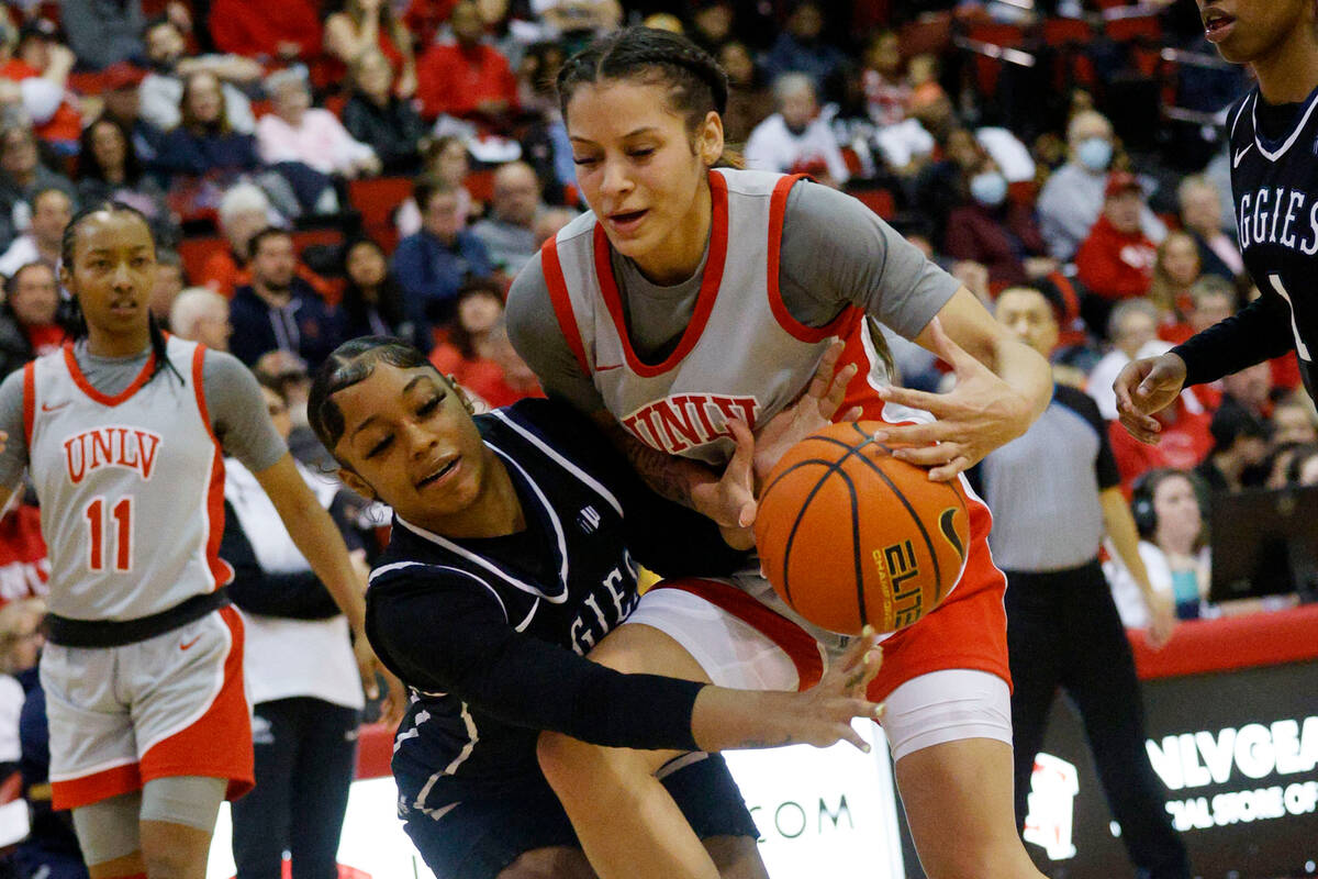 Utah State Aggies guard Isabella Tanedo (2), left, and UNLV Lady Rebels guard Essence Booker (2 ...