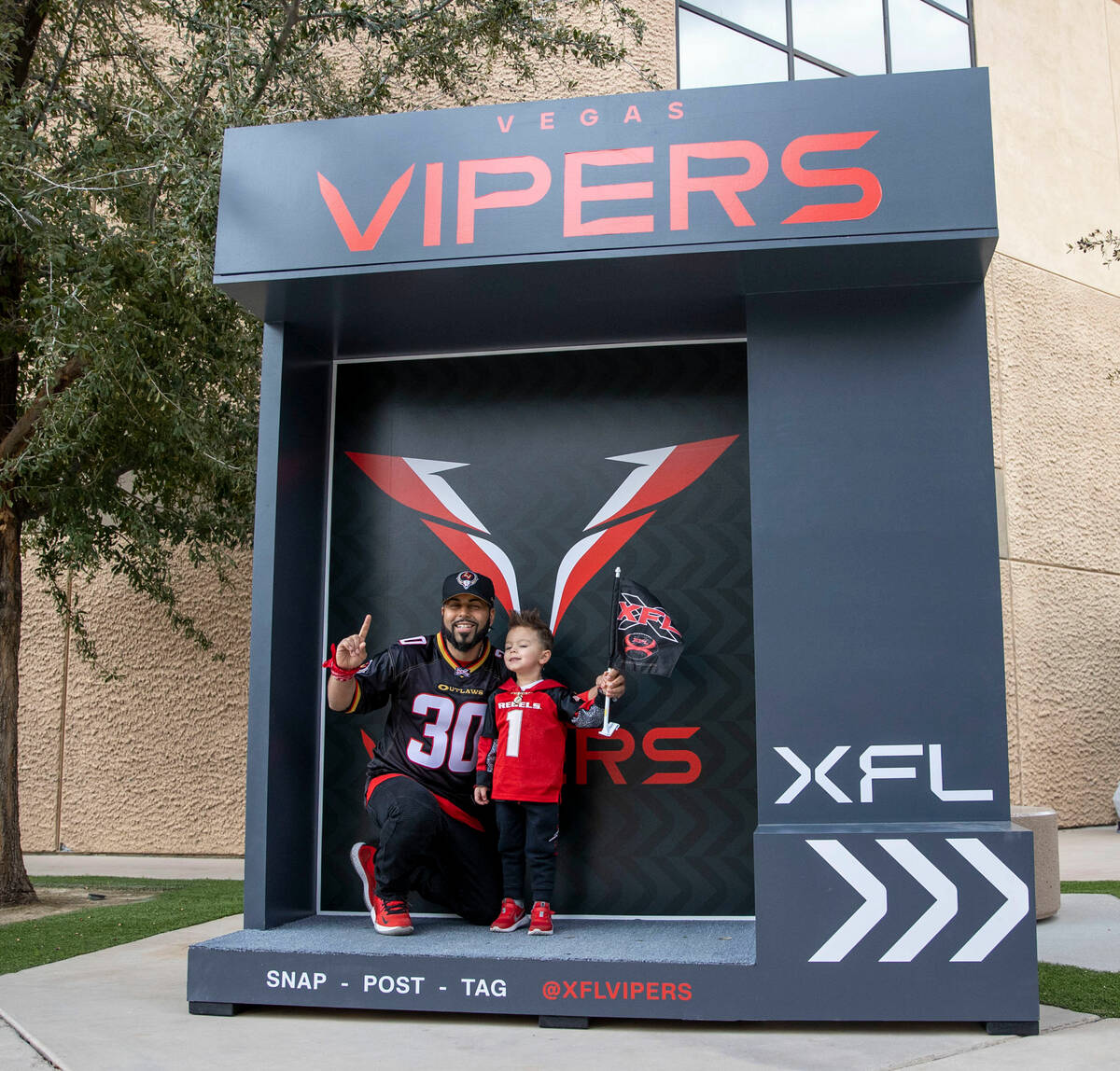 Freddy Figueroa, left, and four-year-old Koa Figueroa pose before an XFL football game between ...