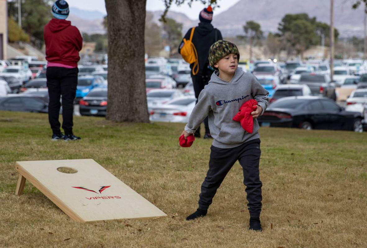 David Fanter, Jr., 7, of Las Vegas, plays cornhole before an XFL football game between the Vega ...