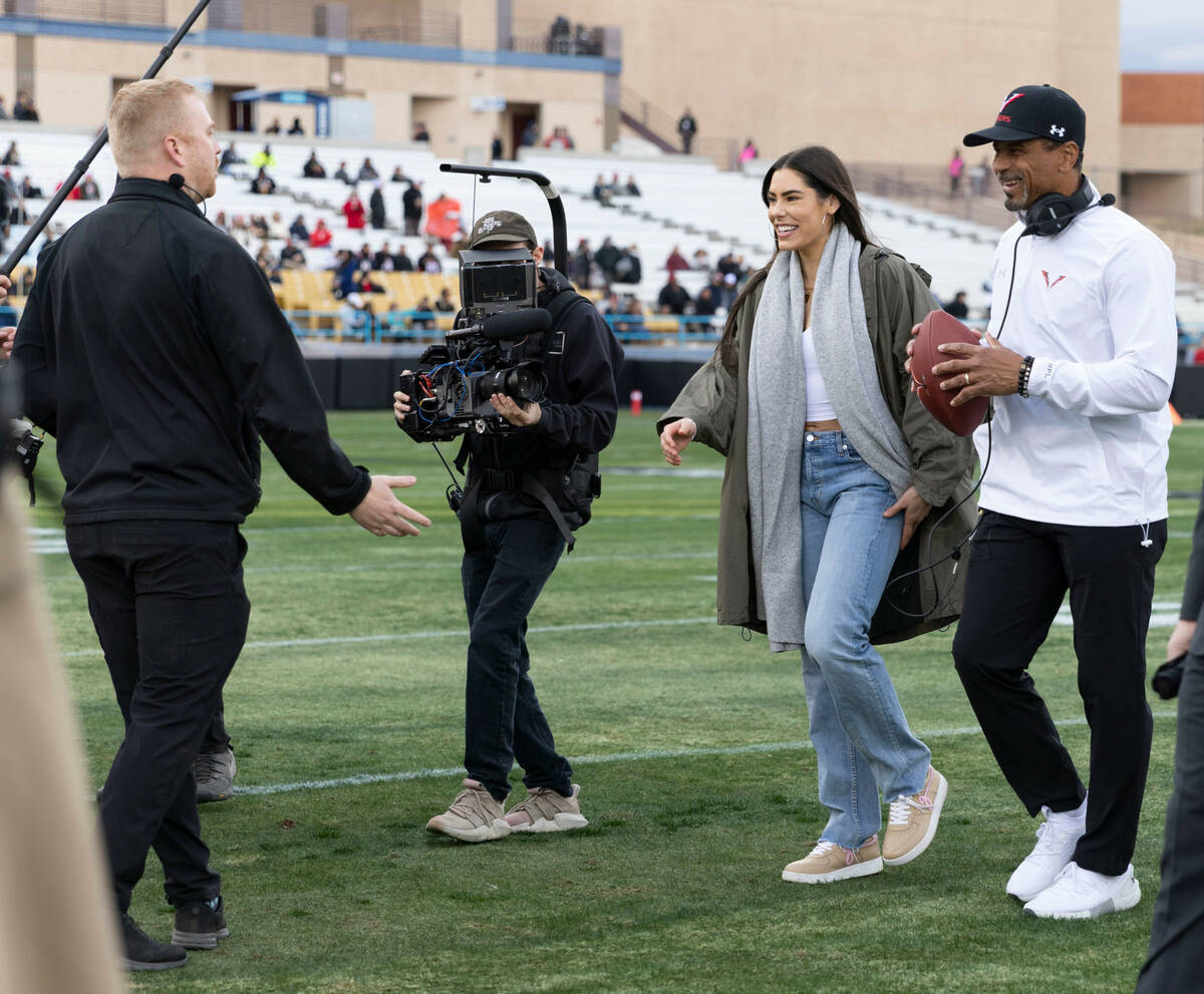 Las Vegas Aces guard Kelsey Plum, left, walks with Vegas Vipers head coach Rod Woodson before a ...