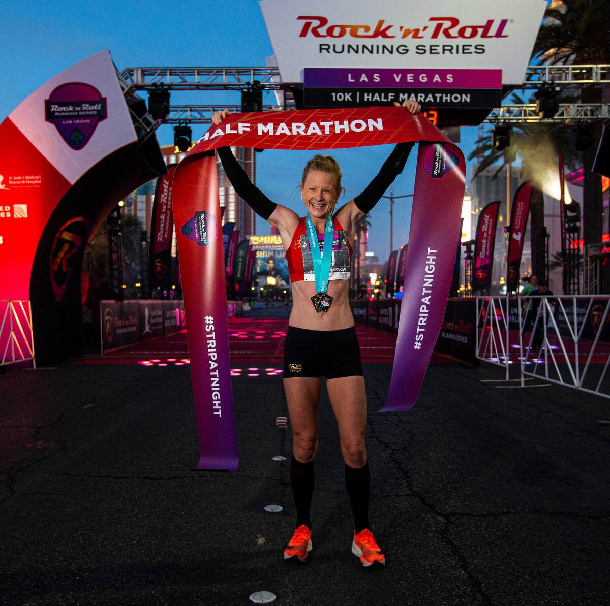 Ellie Stevens, of Las Vegas, poses for photographers after winning the women’s Rock &#x2 ...