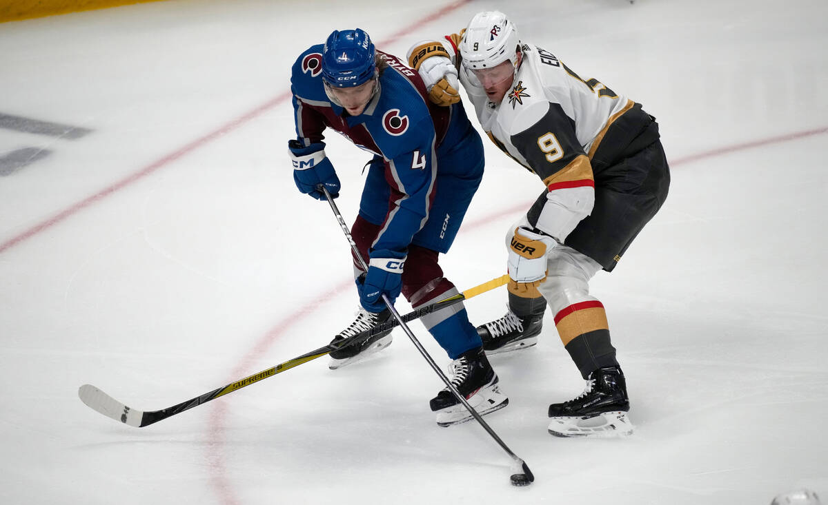 Colorado Avalanche defenseman Bowen Byram, left, shoots as Vegas Golden Knights center Jack Eic ...