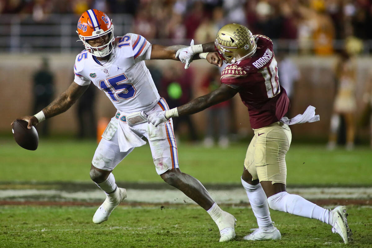 Florida quarterback Anthony Richardson (15) is pressured by Florida State defensive back Jammie ...