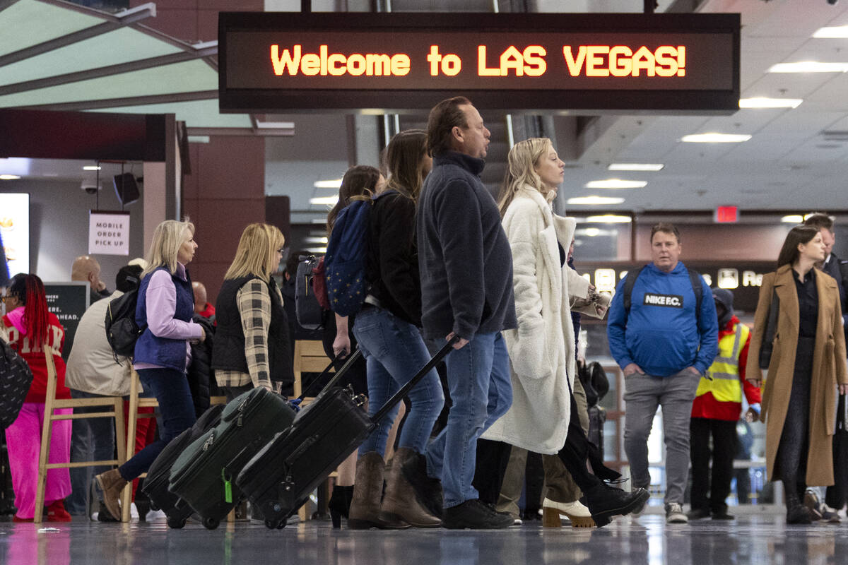 People arrive to the baggage claim area of Terminal 1 at Harry Reid International Airport in La ...