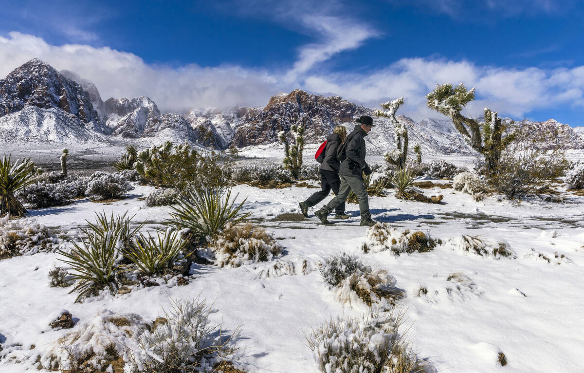 Visitors Andreas and Heidi Dornauf of Germany make their way to a viewpoint ridge overlooking t ...