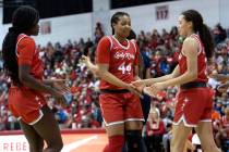 UNLV forward Alyssa Brown (44) slaps hands with guard Jasmyn Lott, left, and guard Kiara Jackso ...