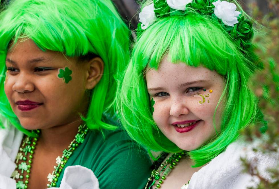 Henderson residents Emi Eighmy, 10, and her friend Allannah Turner, 8, don green hair while wat ...