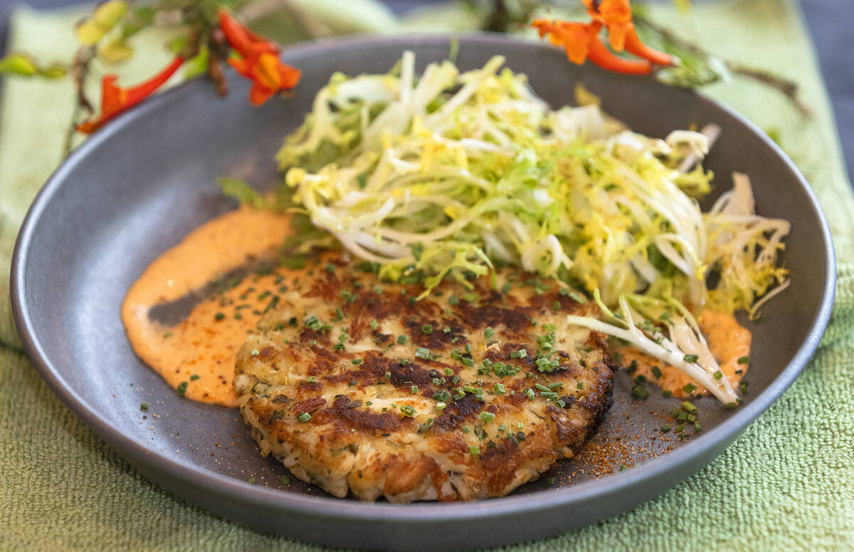 Crab cake served with frisée salad is displayed at Table 34 at 600 E. Warm Springs Road, on Fr ...