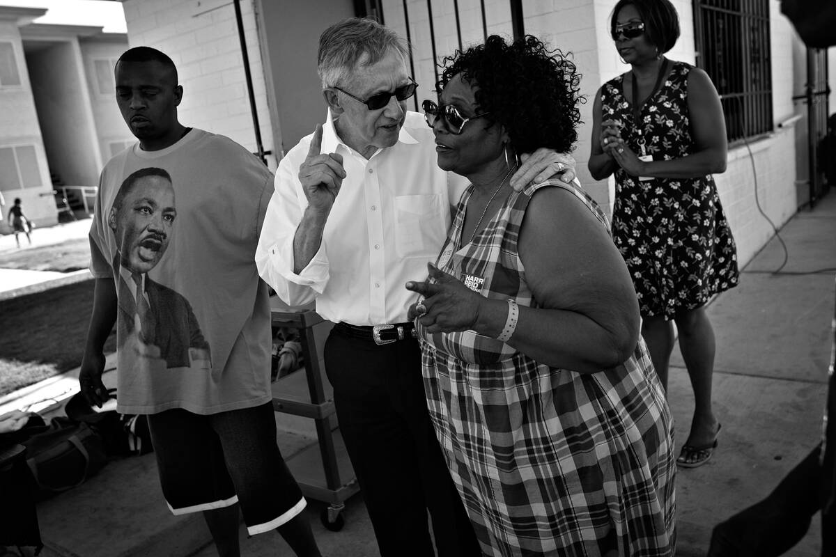 Sen. Harry Reid, D-Nev., speaks with Las Vegas activist Ruby Duncan while campaigning at a bloc ...