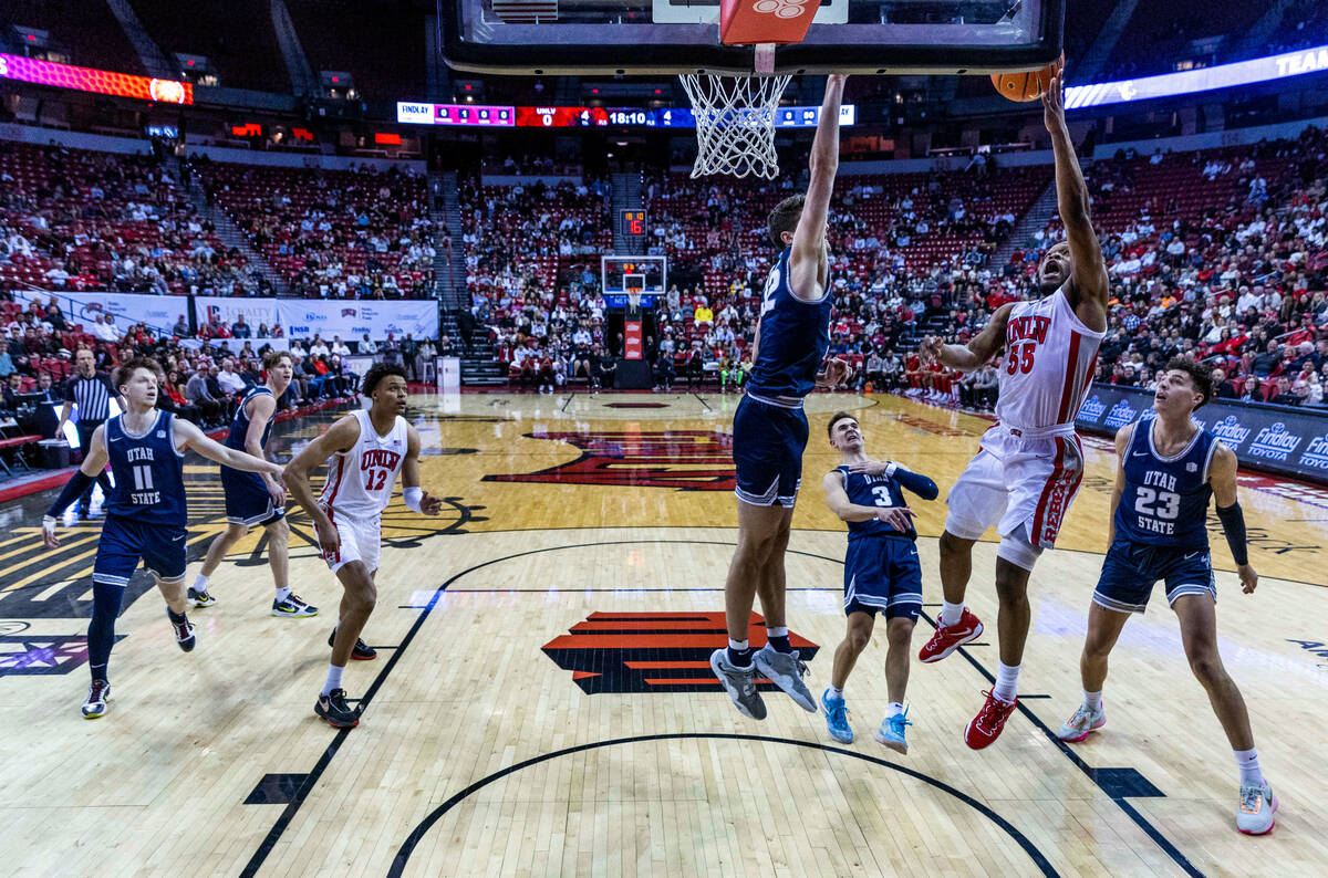 UNLV guard EJ Harkless (55) sets up for a shot over Utah State center Trevin Dorius (32) during ...