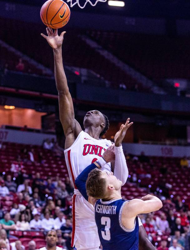 UNLV forward Victor Iwuakor (0) elevates over Utah State guard Steven Ashworth (3) for a shot d ...