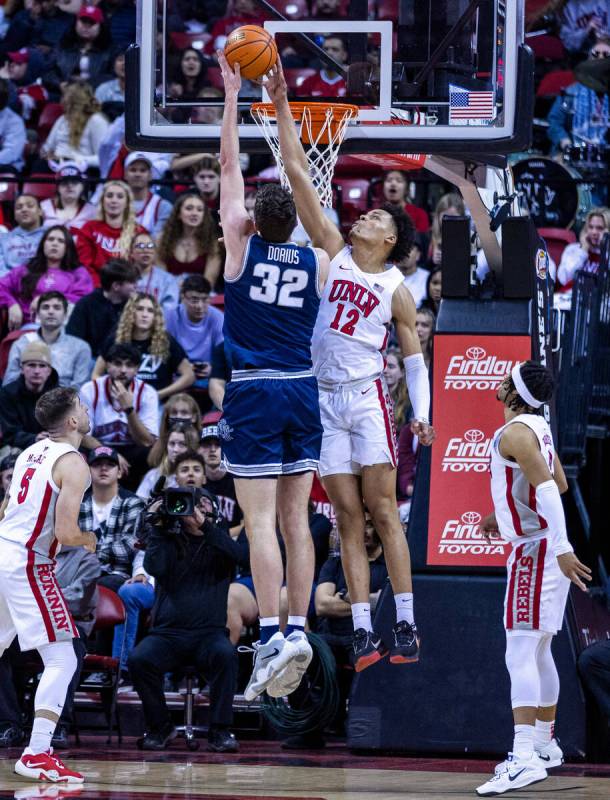 UNLV center David Muoka (12) blocks a shot by Utah State center Trevin Dorius (32) during the f ...