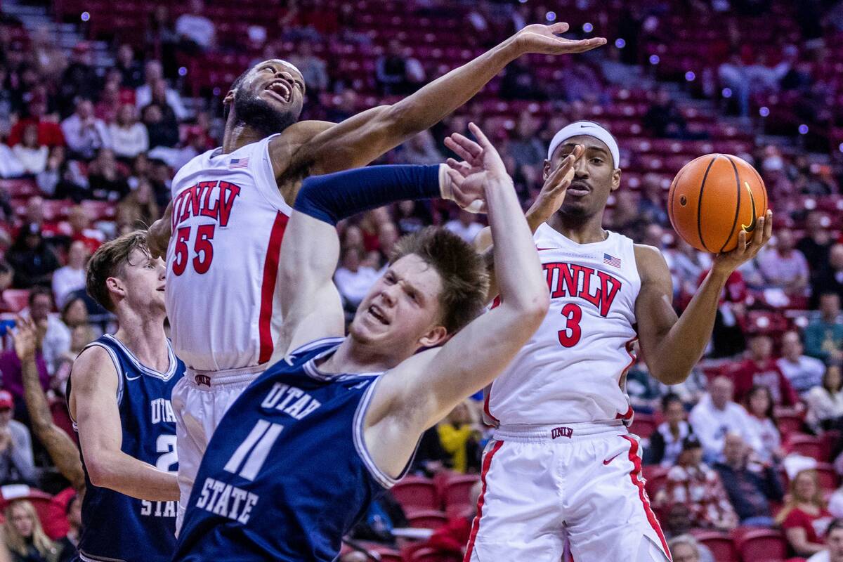 UNLV guard Shane Nowell (3) and guard EJ Harkless (55) secure a rebound from Utah State guard M ...