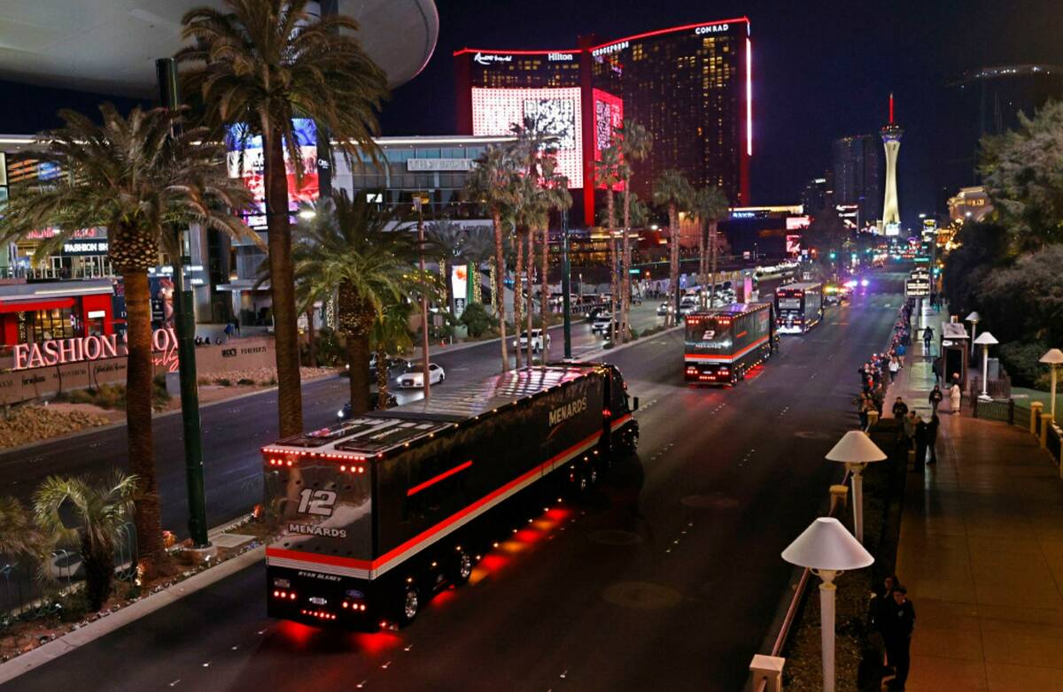 NASCAR Cup Series haulers including the hauler of Ryan Blaney (12) parade down the Las Vegas St ...