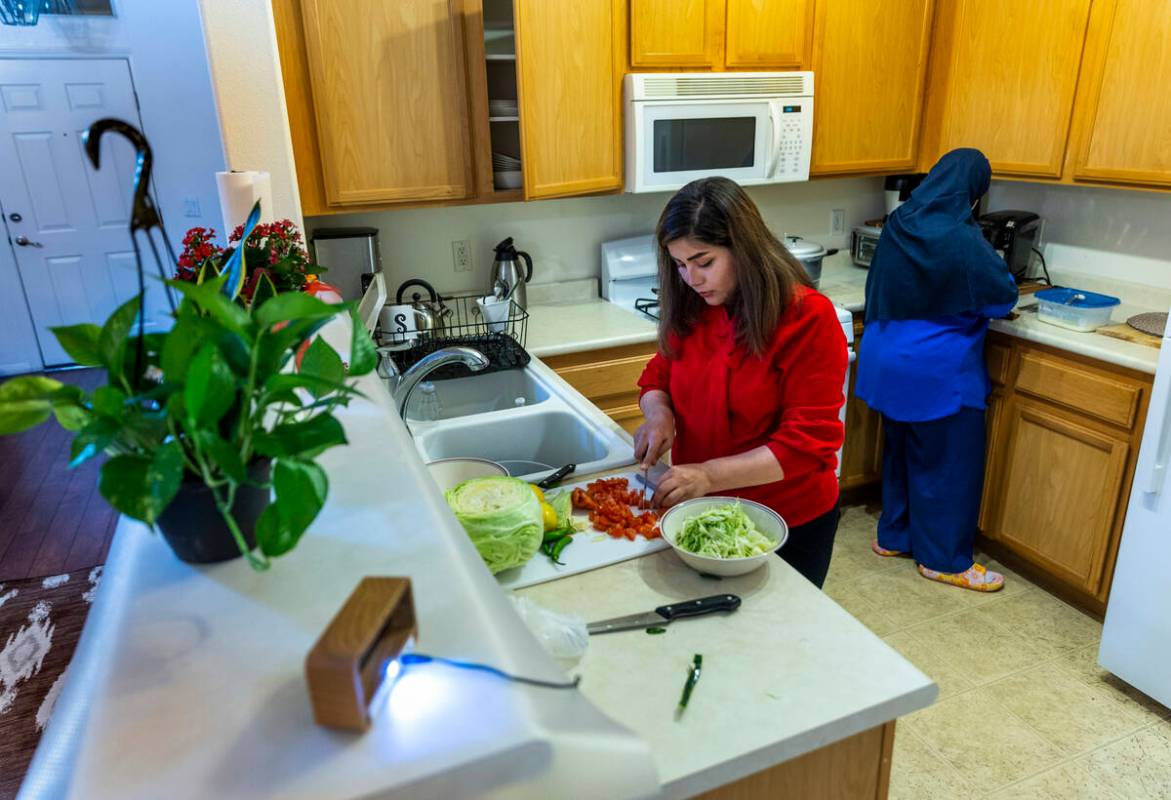 Shabana and her mother-in-law, Nazanin, prepare dinner in their apartment on Tuesday, Feb. 28, ...
