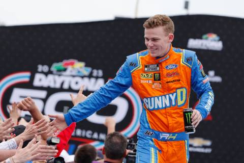 Riley Herbst greets fans during driver introductions before the NASCAR Daytona 500 auto race at ...