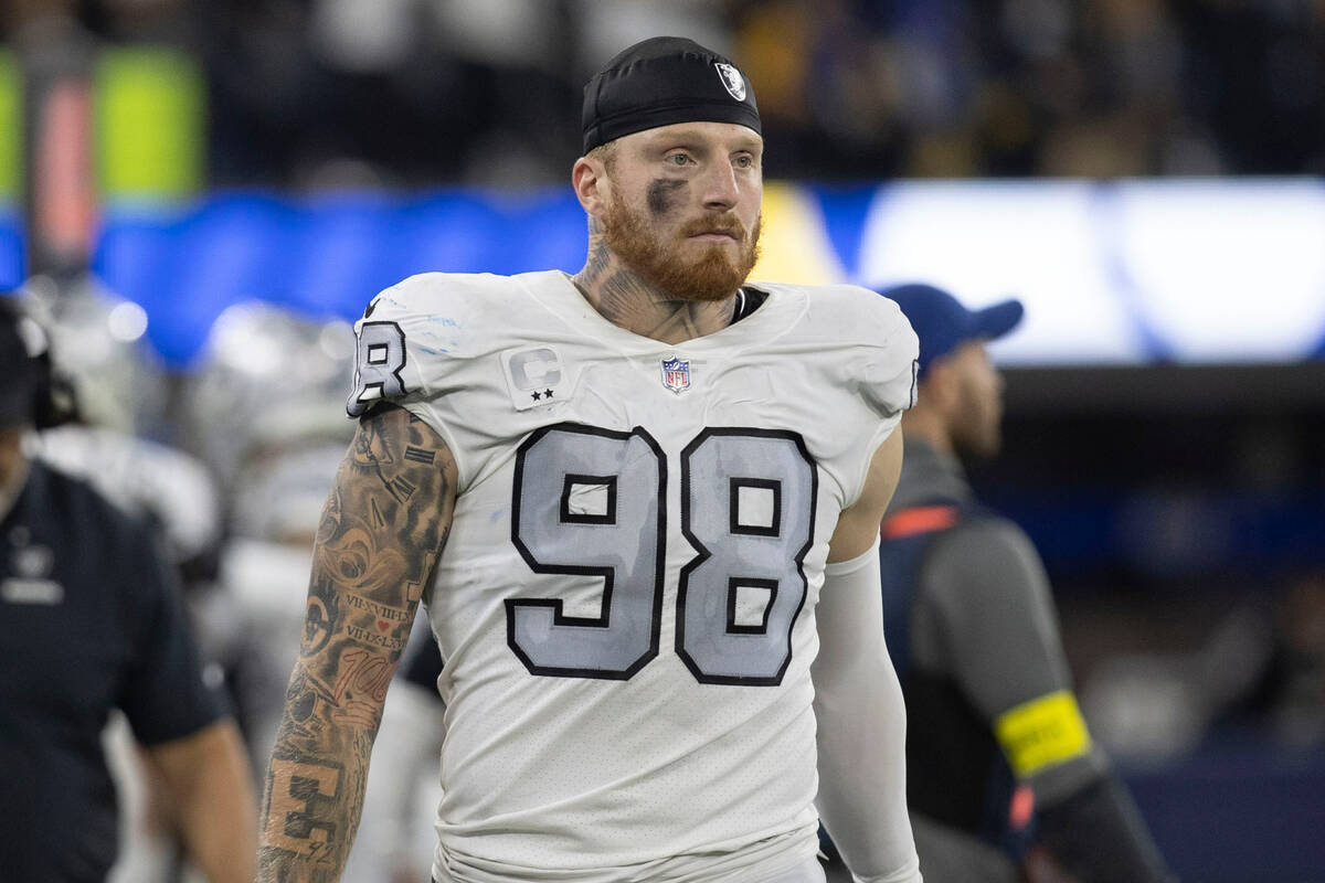 Raiders defensive end Maxx Crosby (98) prepares to go back on the field after the against the L ...